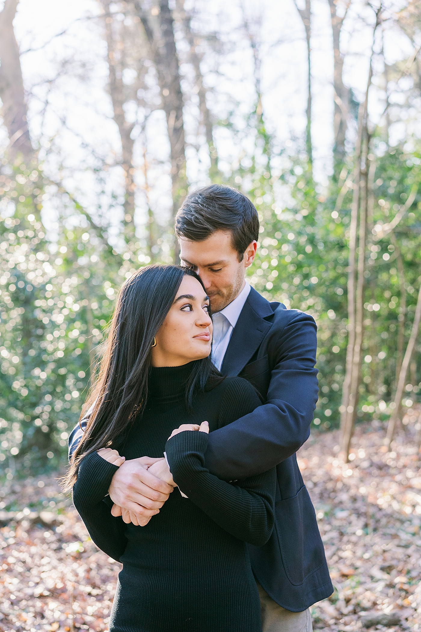 Couple snuggling during their engagement session | Image by Annie Laura Photo