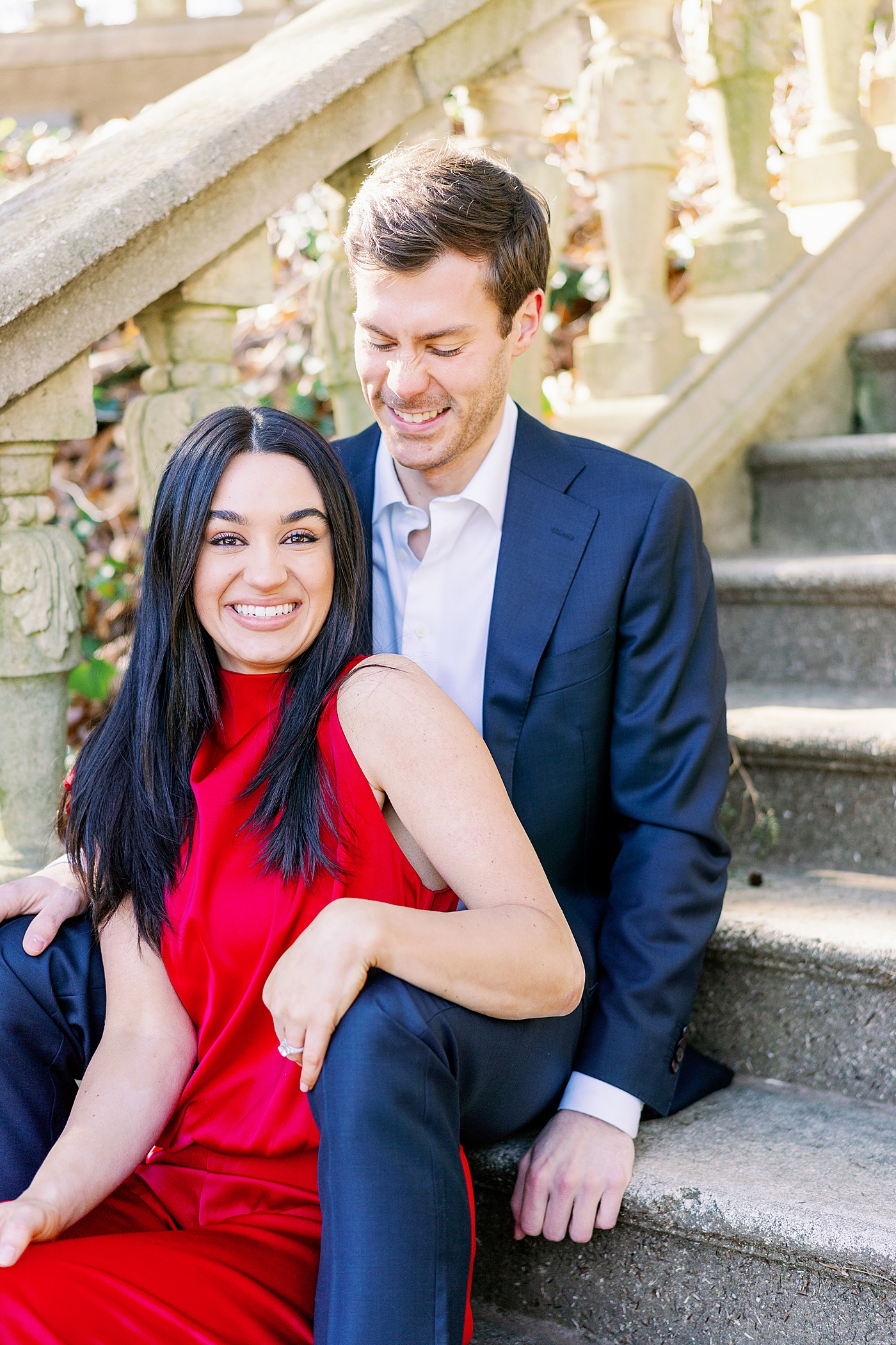 Smiling couple sitting on a stone staircase | Image by Annie Laura Photo