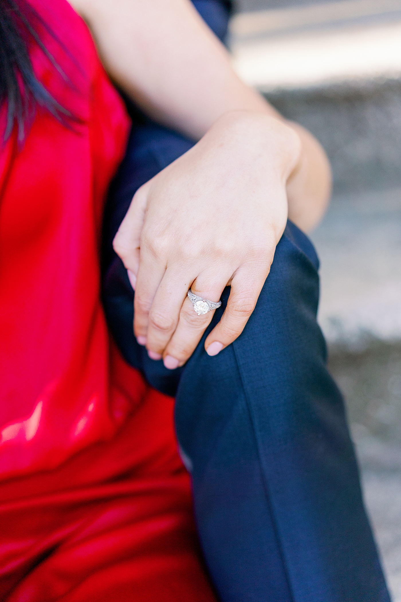 Detail of bride's ring on her hand resting on her fiances' knee | Image by Annie Laura Photo