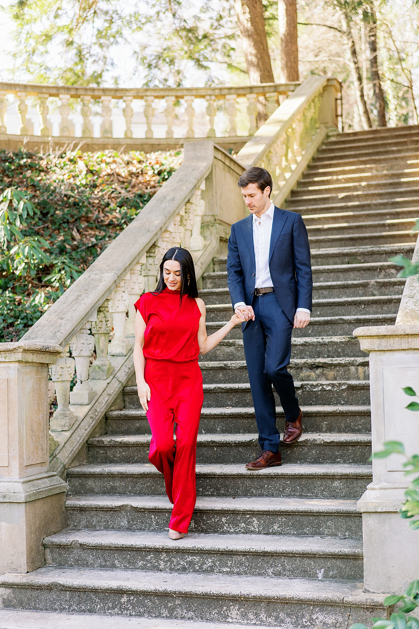 Couple in red and blue walking down stone staircase | Image by Annie Laura Photo