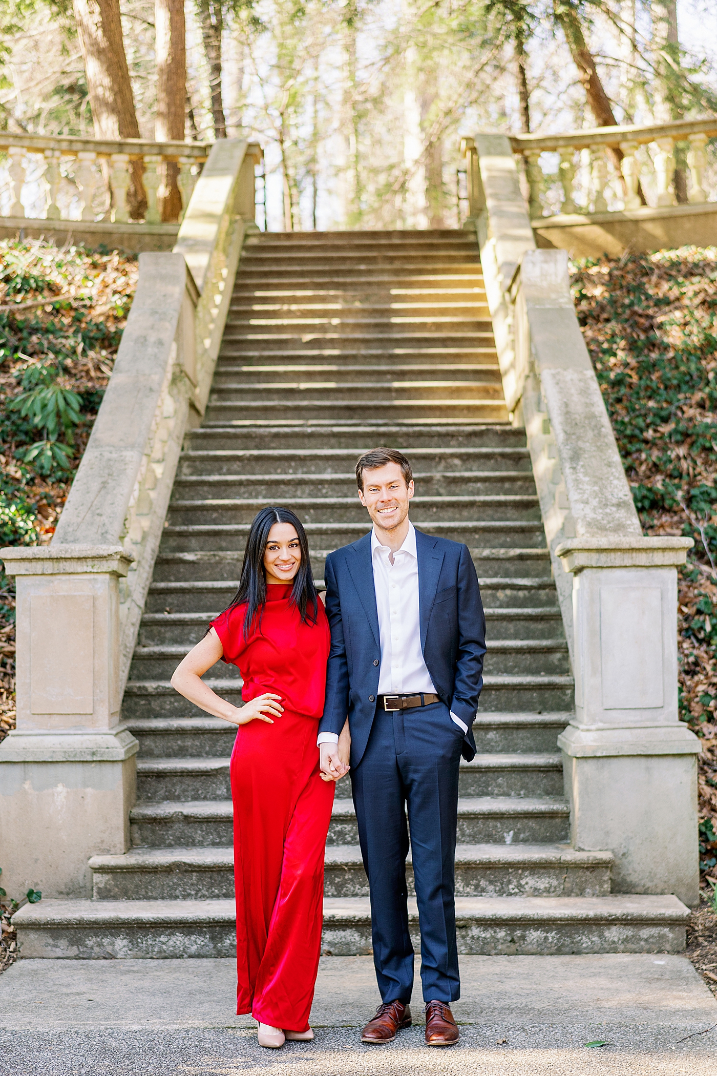 Couple holding hands posing in front of stone staircase | Image by Annie Laura Photo