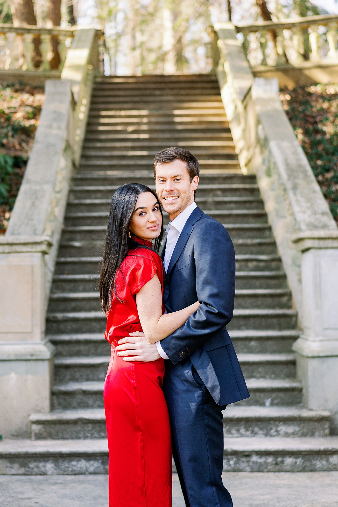 Couple in red and blue posing in front of stairs | Image by Annie Laura Photo