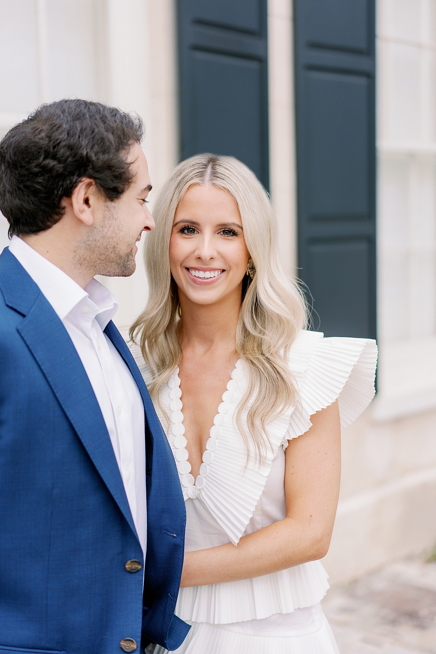 Bride looking at the camera while groom looks at her | Intimate Charleston Engagement Session with Annie Laura Photo