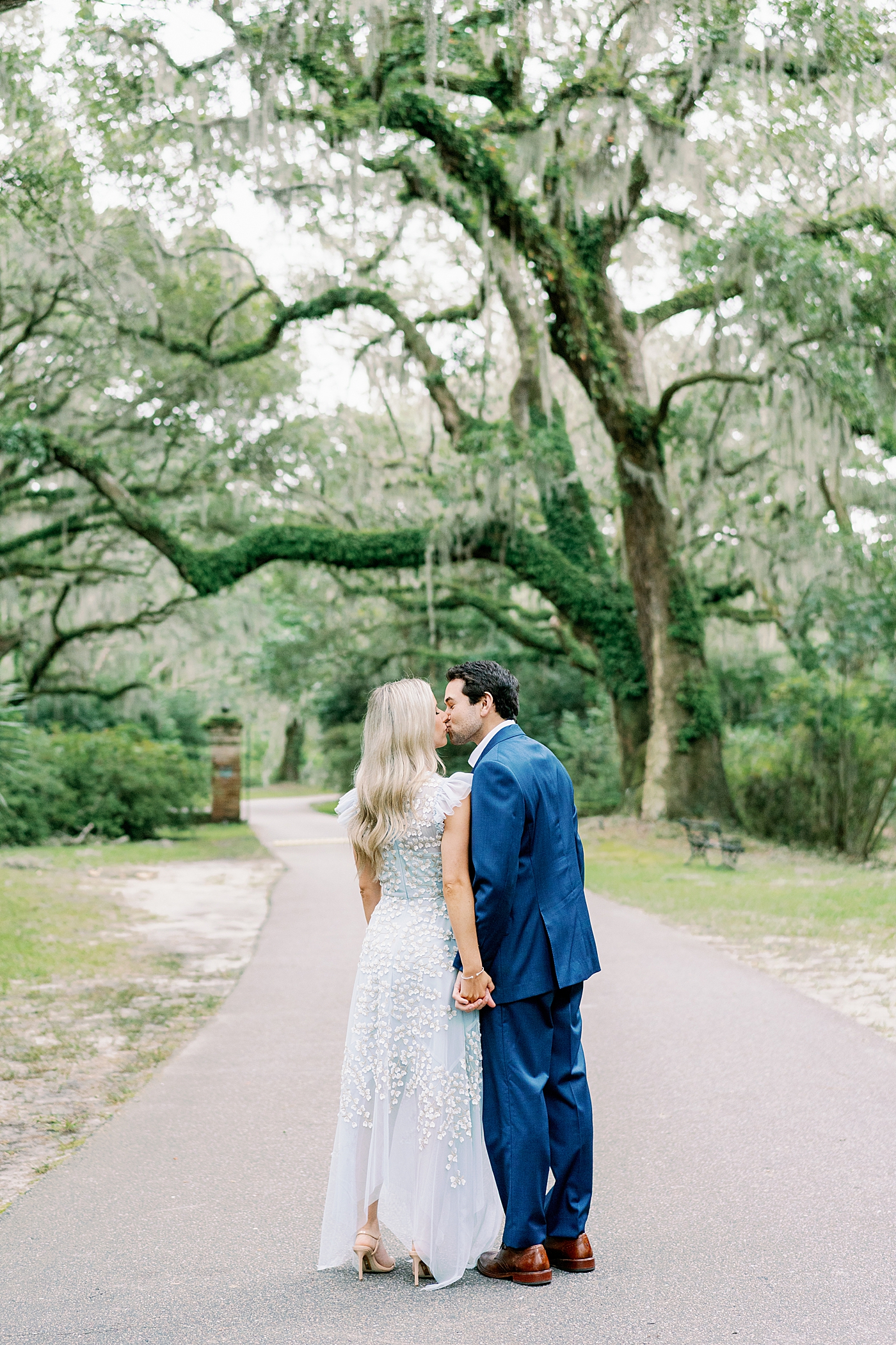 Couple kissing walking on a path | Image by Annie Laura Photo