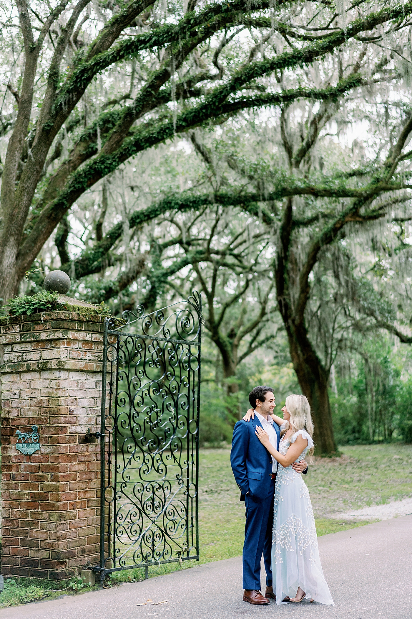 Couple posing near iron gates at Legare Waring House | Image by Annie Laura Photo