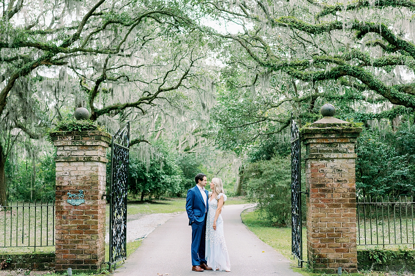 Couple standing near an iron gate | Image by Annie Laura Photo