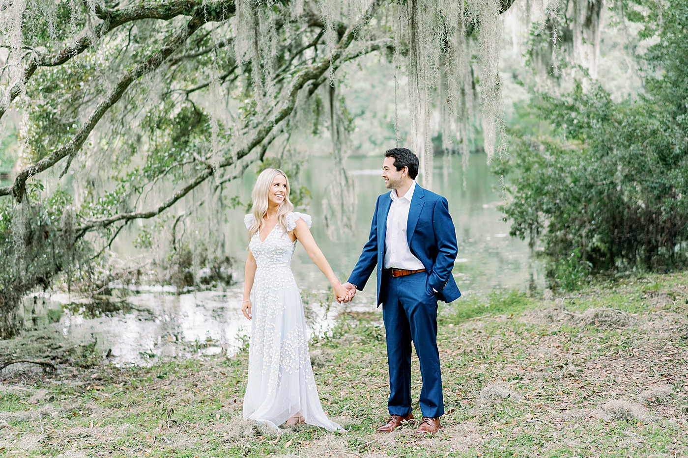 Couple holding hands under oak trees and spanish moss | Image by Annie Laura Photo