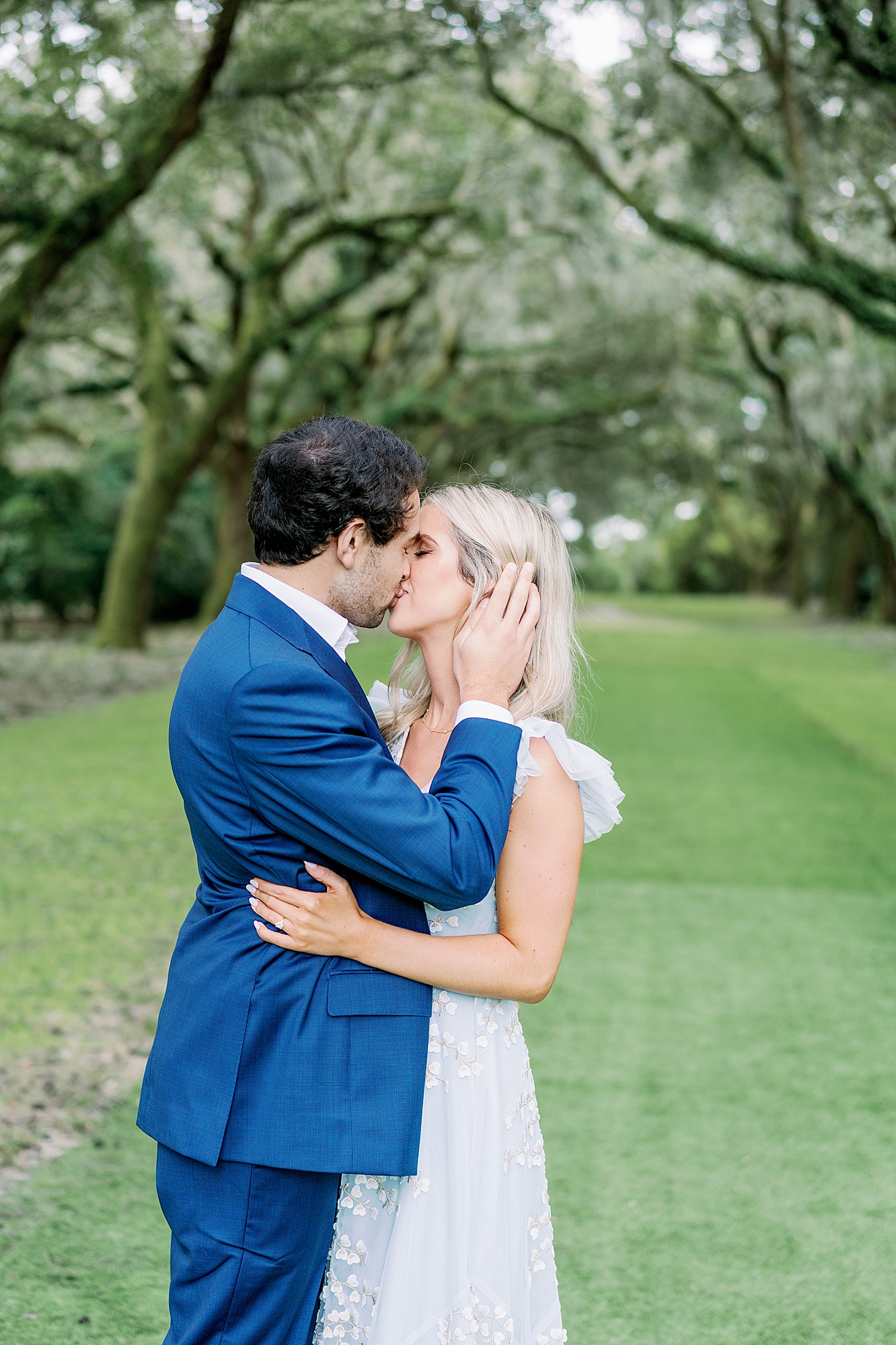 Couple kissing under oak trees | Intimate Charleston Engagement Session with Annie Laura Photo