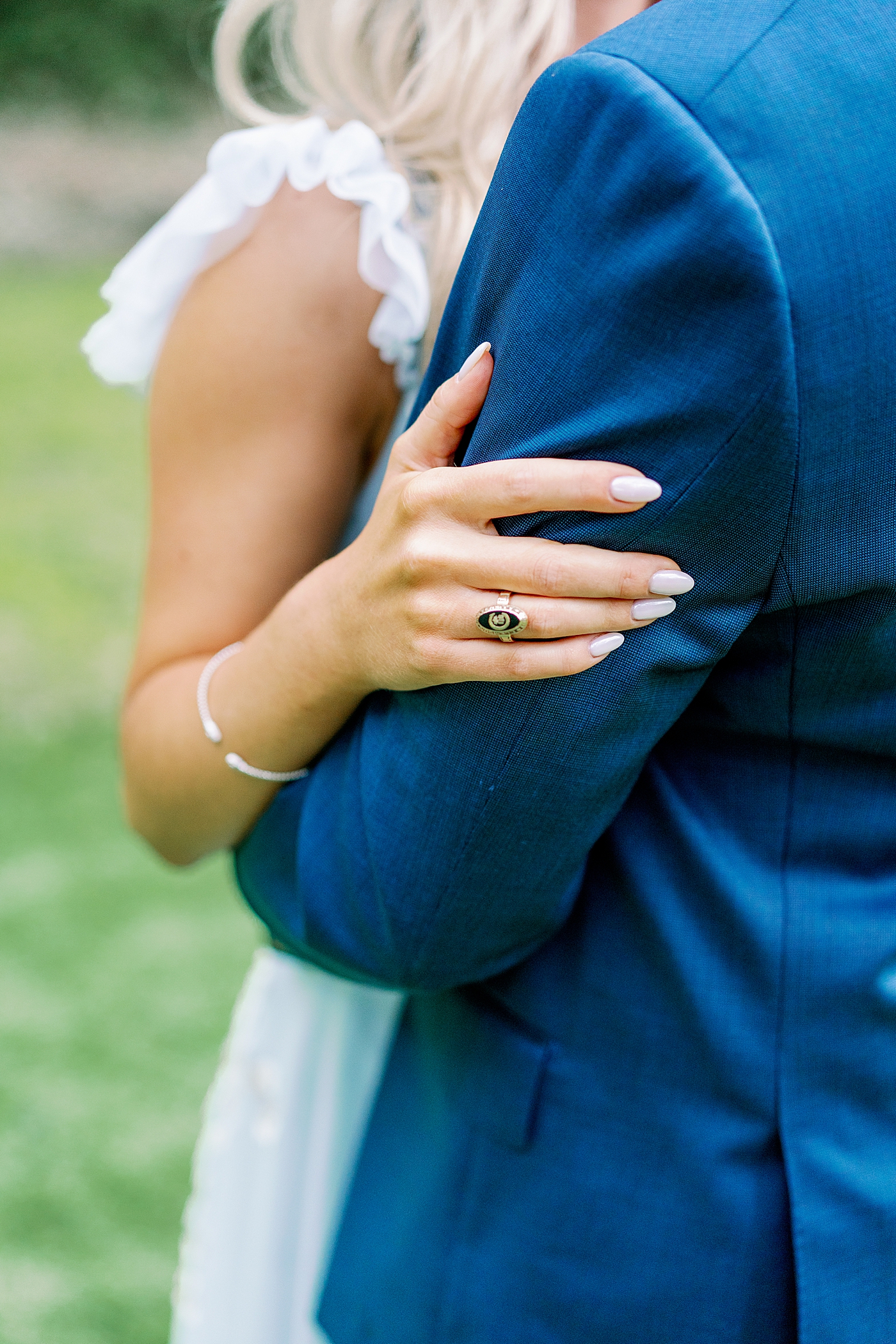 Detail of couple embracing and clemson college ring | Image by Annie Laura Photo