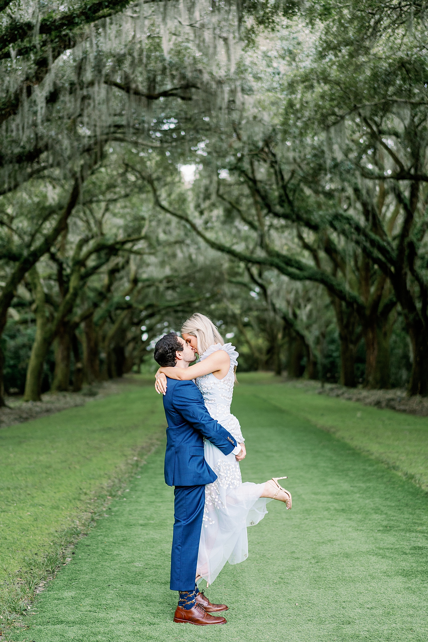 Groom to be holding bride to be while kissing her | Intimate Charleston Engagement Session with Annie Laura Photo