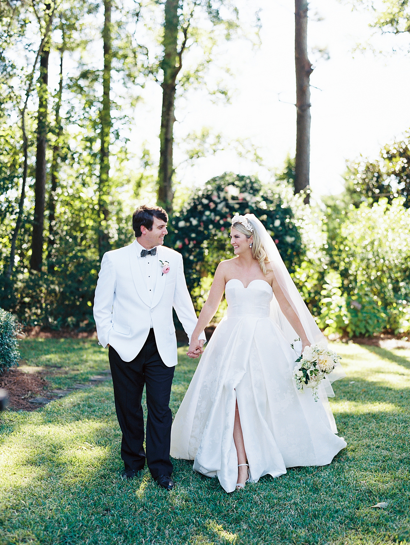 Bride and groom walking holding hands | Image by Annie Laura Photo
